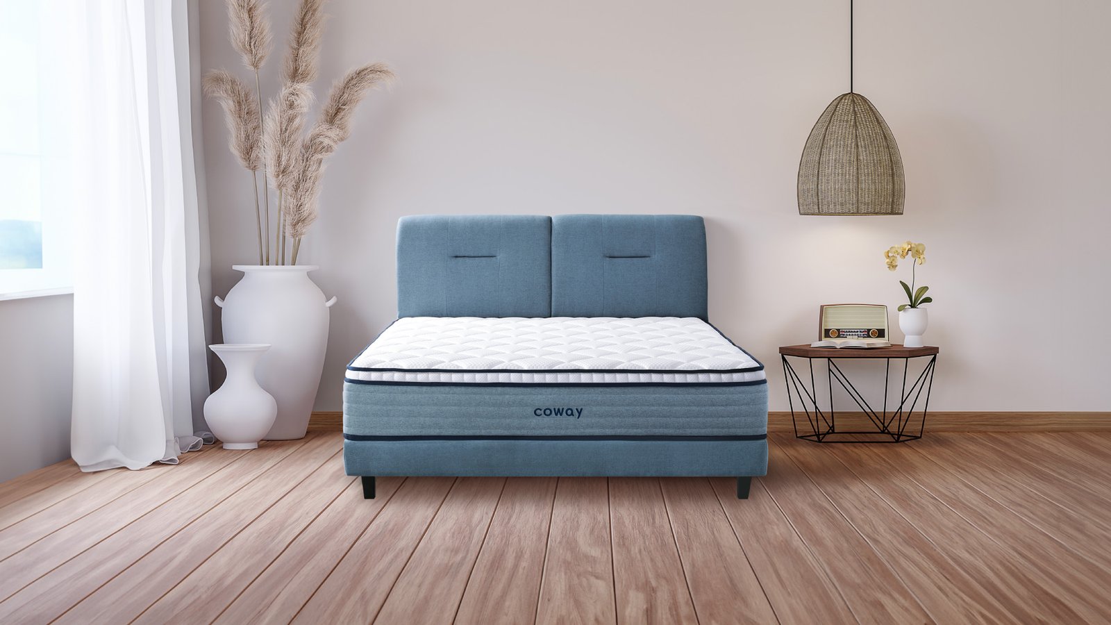 coway-prime-lite-series-mattress-at-the-center-of-the-room-with-wooden-floors-and-a-huge-decorative-plant-vase-at-the-side.jpg